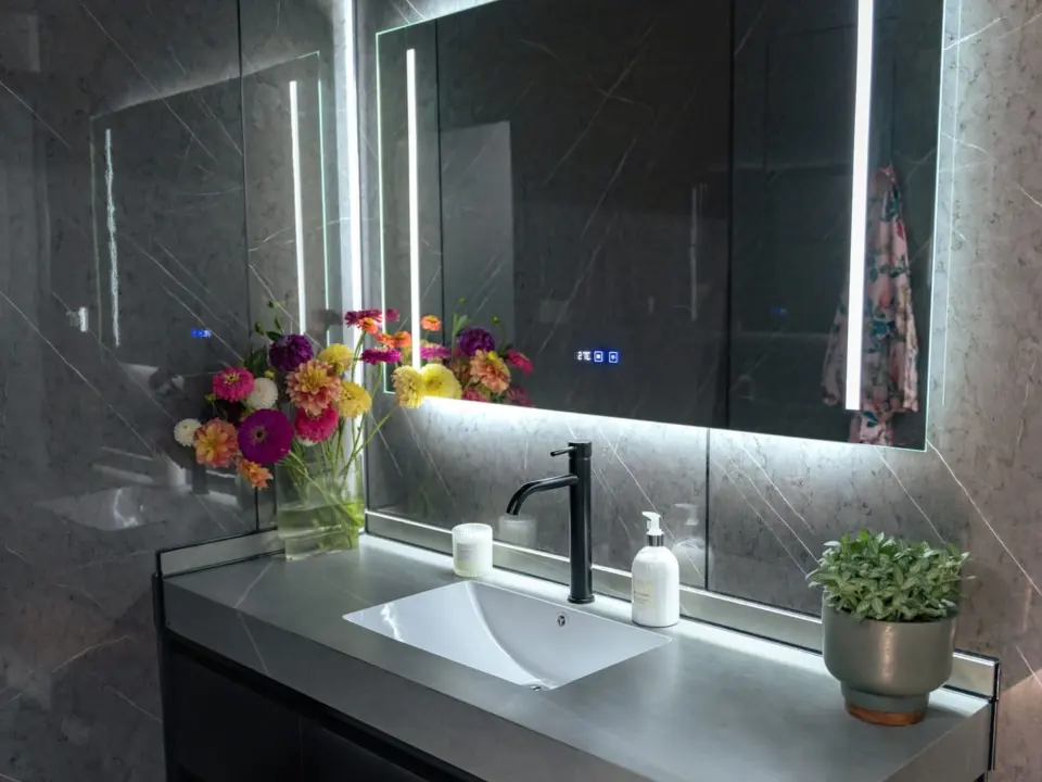 Aluxria capsule bathroom with backlit mirror and stone basin