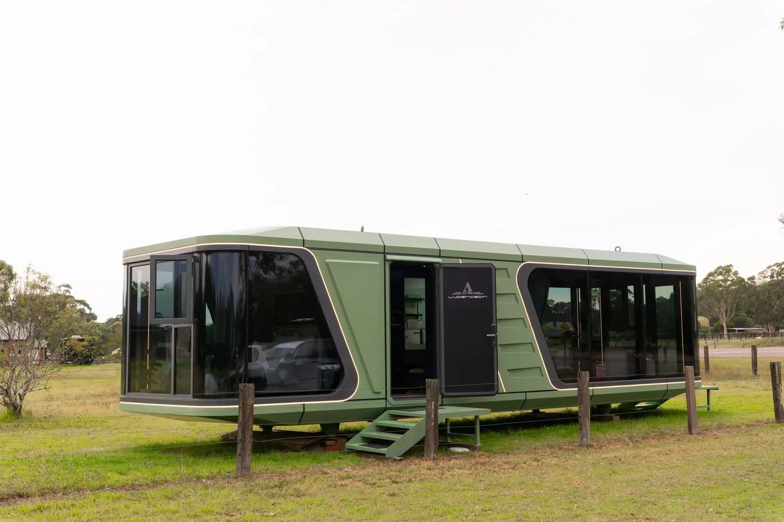 Aluxria capsule in sage green on a grassy site