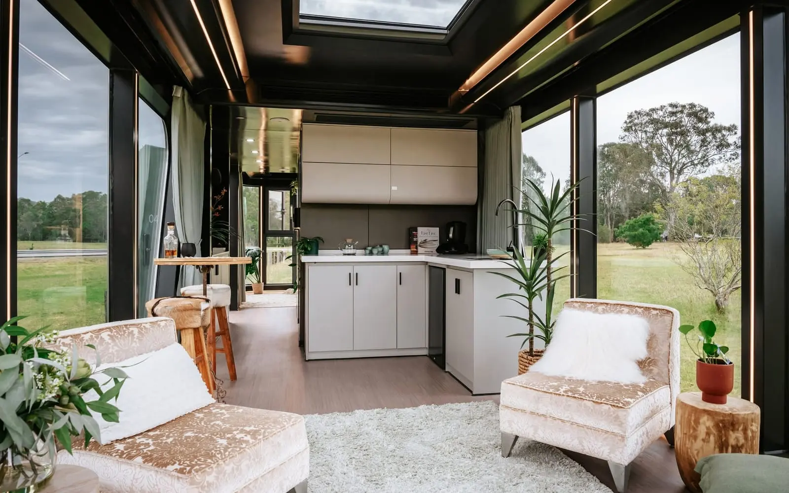 Aluxria capsule interior with skylight, kitchen and lounge chairs