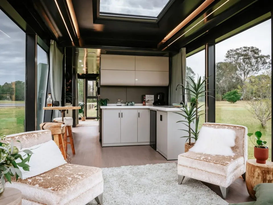 Aluxria capsule interior with skylight, kitchen and lounge chairs