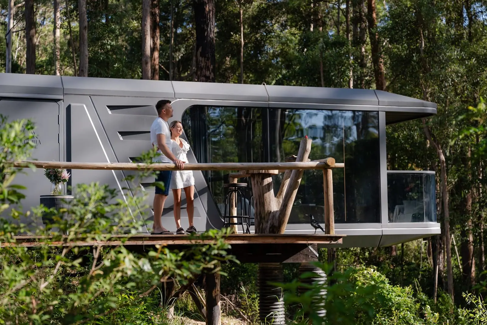 Aluxria capsule with raised timber deck among trees