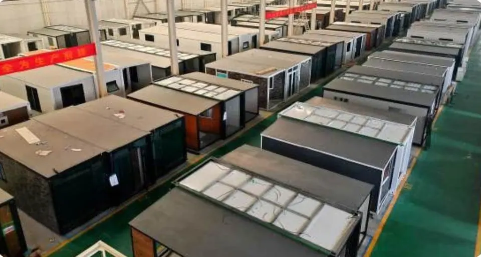 Rows of expandable houses in production on a factory floor