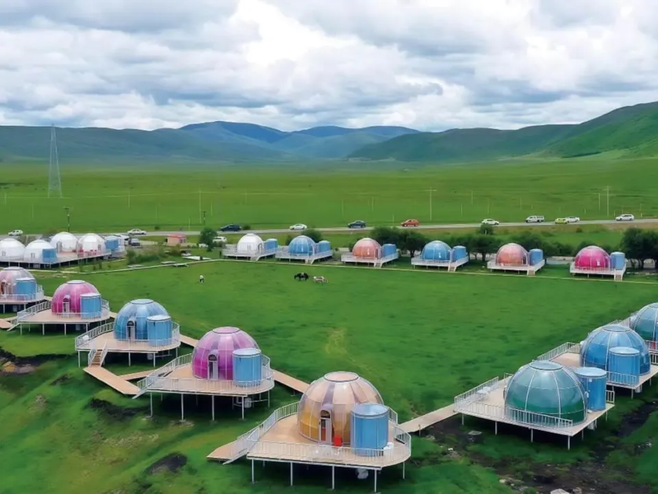 Dome houses on raised decks in a green valley